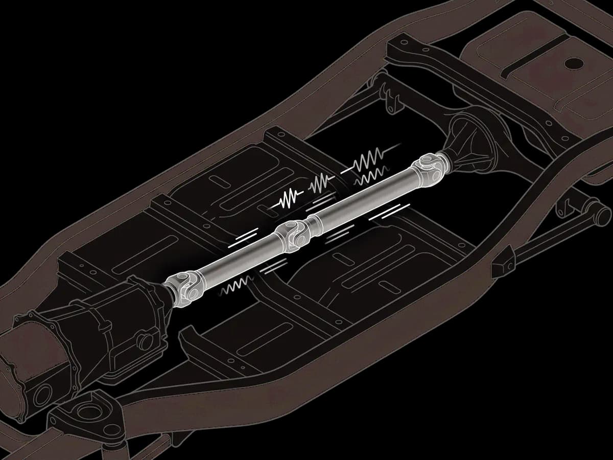 A driveshaft vibrating under a vehicle.